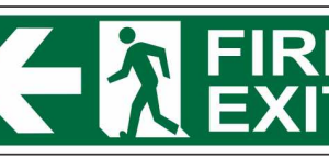 Green FIRE EXIT sign with a running-person symbol and left-pointing arrow by Safe Cure